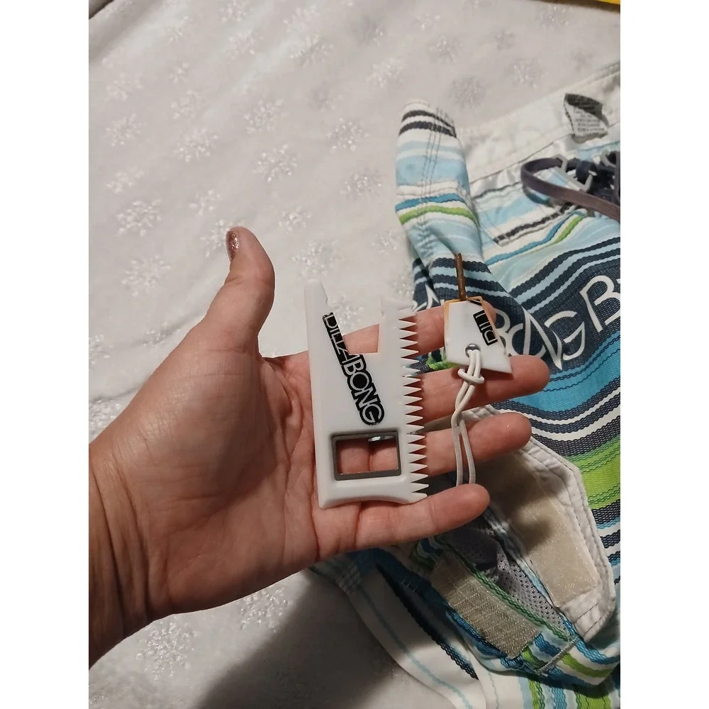 Billabong Board Shorts Size 30 with an attached fire starter and bottle opener